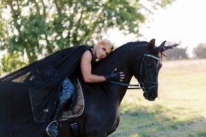 Groom Wearing Cape on Horse Dressed as Unicorn