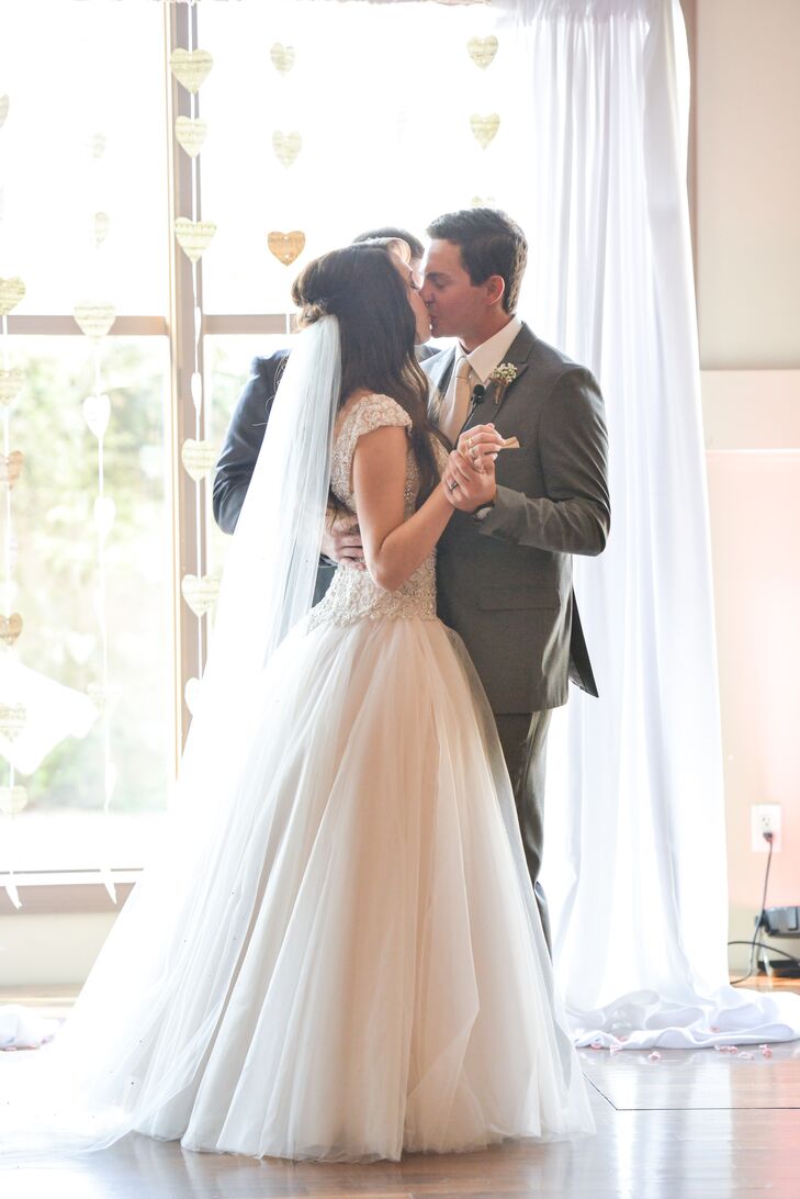 One of Brittney's most meaningful DIY projects was creating a heart garland out of her grandmother's vintage sheet music. The hanging heart garland created the backdrop of Brittney and Josh's ceremony and first kiss.