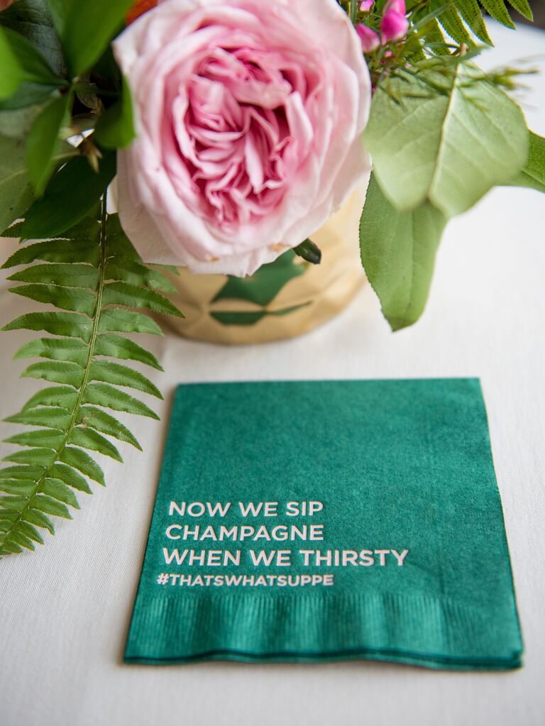 Turquoise cocktail napkin with rap lyrics printed on it.