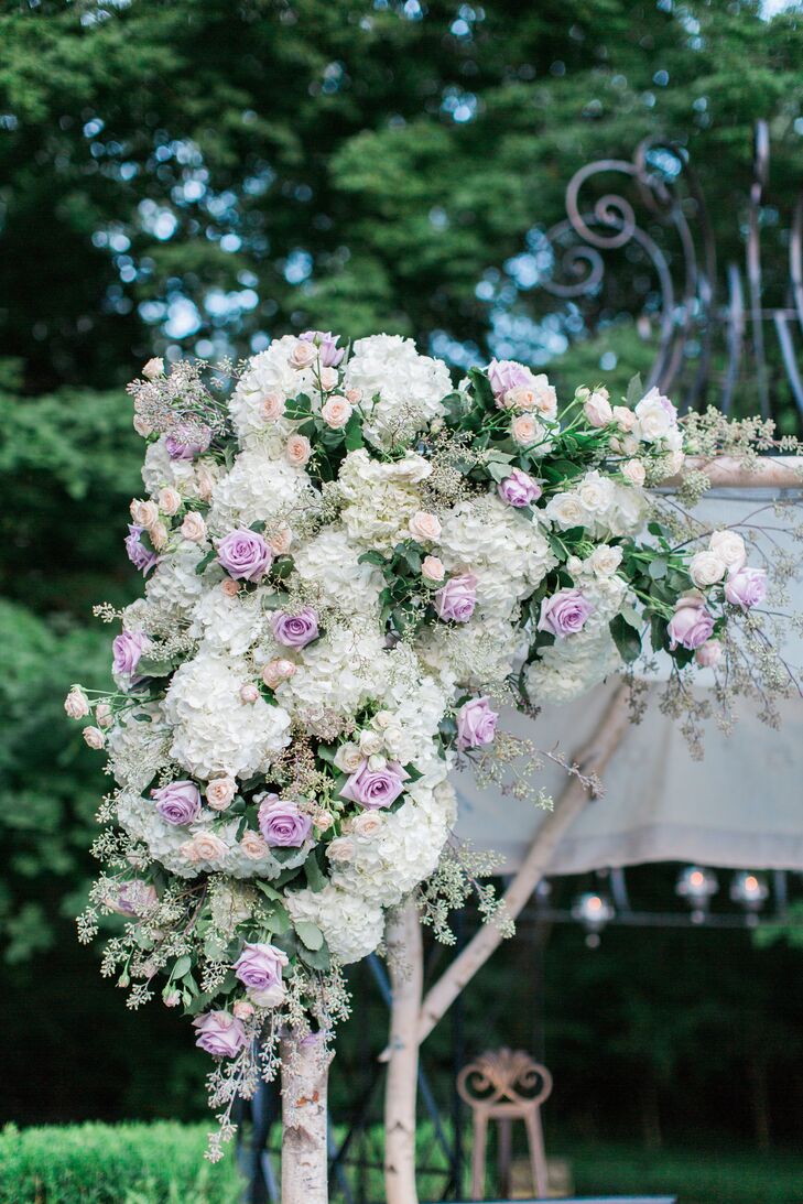 The couple wed under a wooden flower-covered chuppah made by the groom's mother. "Jesse is one of four siblings, and each corner of the chuppah had a sibling's and spouse's names embroidered," Tara says.
