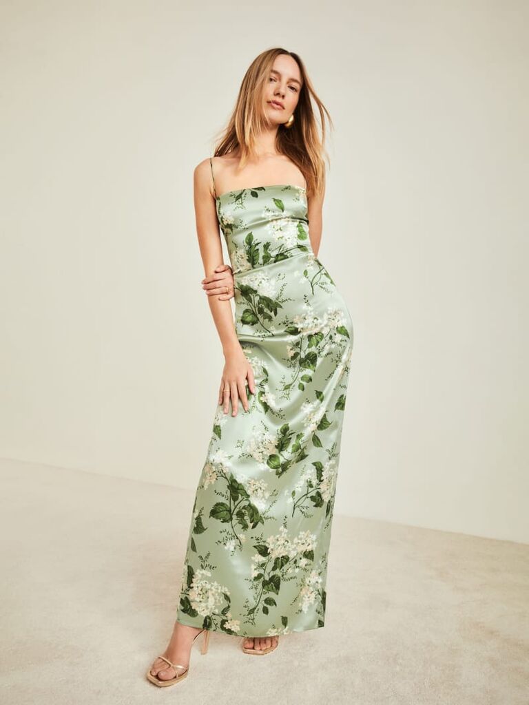Model wearing a light green maxi dress with an elegant flower print
