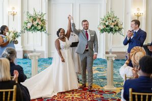 Bride and Groom Starting Recessional in Hotel Ballroom, Altar Arrangements on Pillars