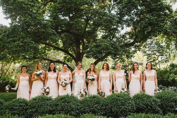 Beth's nine bridesmaids wore peach floor-length Amsale dresses in alternating styles based on each woman's preference.