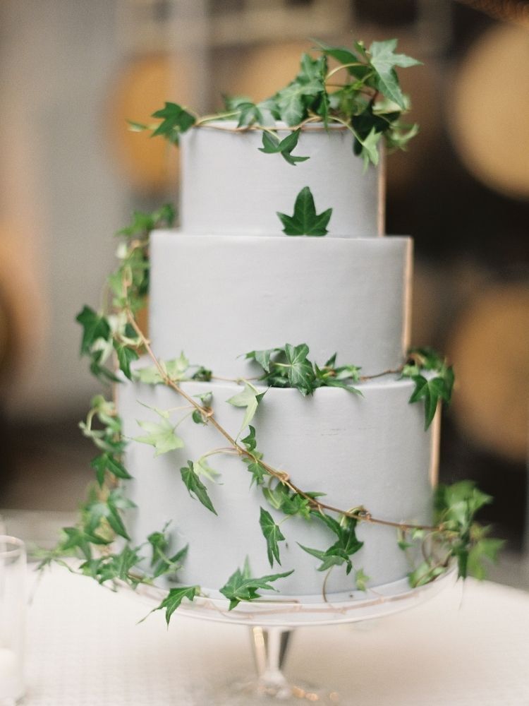 three-tier wedding cake decorated with ivy vines