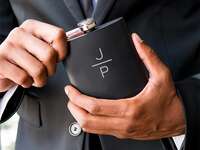 Black flask with minimalist monogram in white