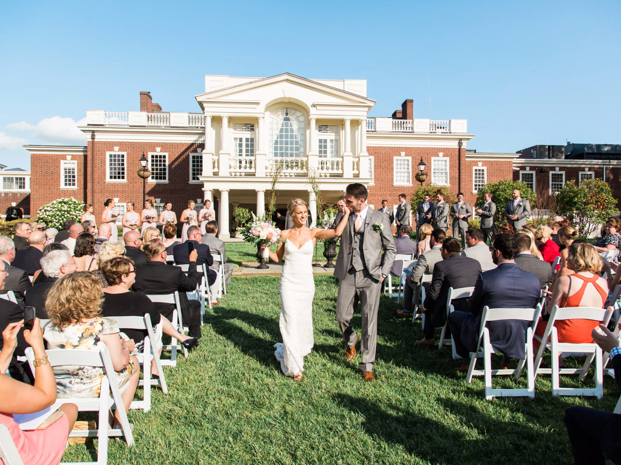 Couple walking down aisle holding hands at The Philadelphia Cricket Club wedding venue