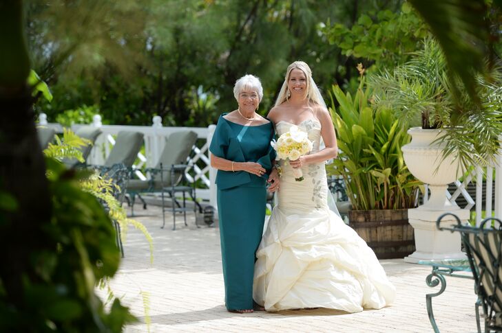 Kristine's mother walked her down the aisle in a teal, bateau neckline, floor-length gown. Kristine's dress "wasn't her original dress," she says. "The dress that I ended up with was a stunning Ines Di Santo dress that I bought from Bridal Reflections in New York a few weeks before my wedding."