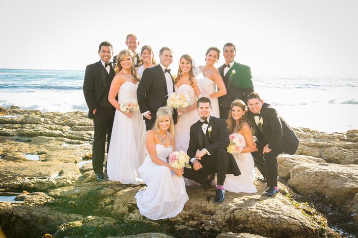 The bridesmaids wore white strapless long dresses while the groomsmen matched the groom and wore black tuxedos.