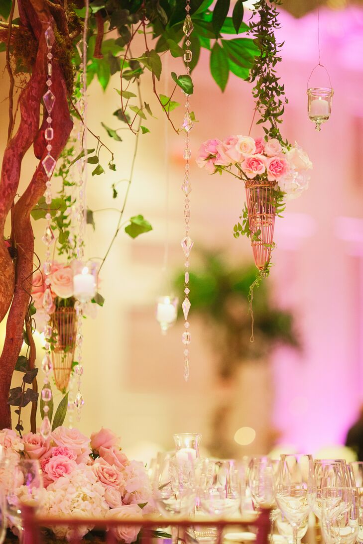Hanging from the six-foot tree-like structures were vases of pink and white roses, votive candles and crystal garland.