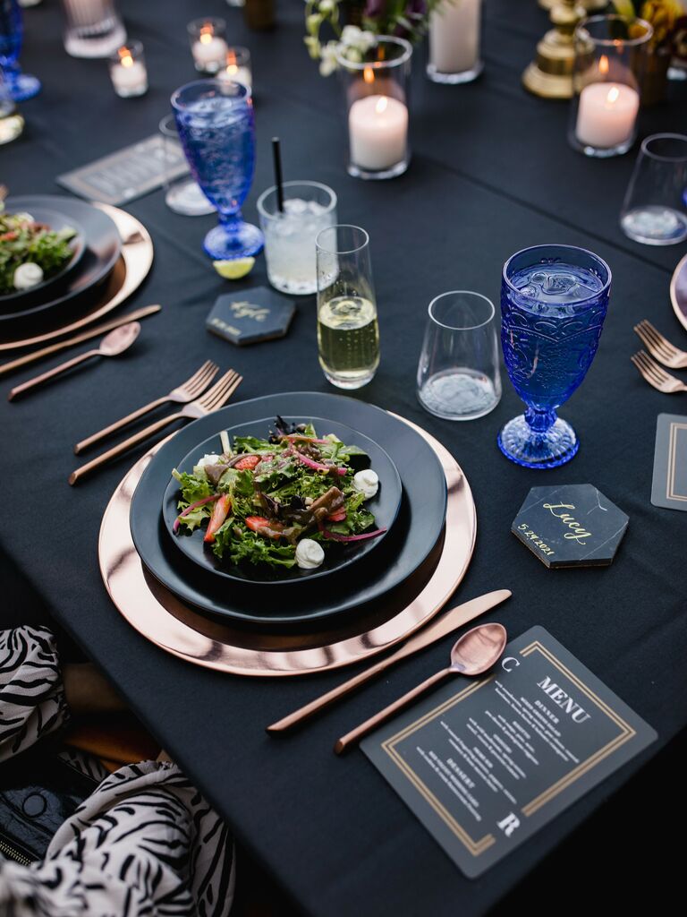 black and royal blue wedding tablescape with rose gold flatware