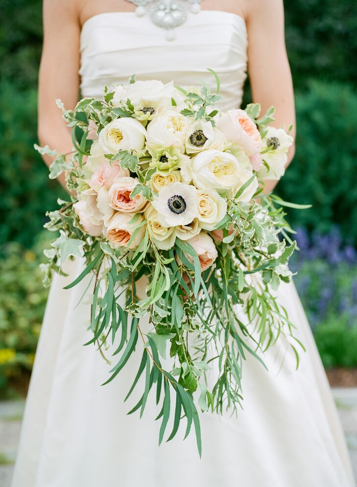 “In the picture of my great-grandmother on her wedding day, she is carrying a cascading bouquet. It is such a romantic look, and I felt it was perfect for my ‘traditional with a twist’ style,” says Katie. Her bouquet included ivory and blush garden roses, ranunculus and anemones surrounded by lush greenery.