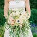 “In the picture of my great-grandmother on her wedding day, she is carrying a cascading bouquet. It is such a romantic look, and I felt it was perfect for my ‘traditional with a twist’ style,” says Katie. Her bouquet included ivory and blush garden roses, ranunculus and anemones surrounded by lush greenery.