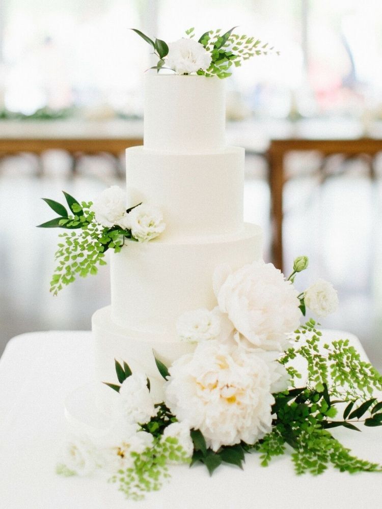 simple spring wedding cake with greenery and flowers