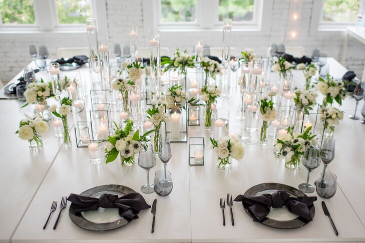 Tablescape With Black Plates, Taper Candles and Greenery