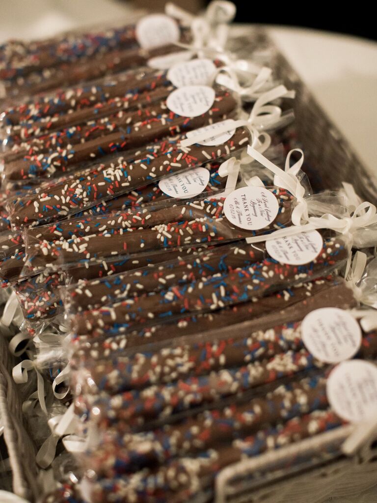 individual wrapped chocolate-covered pretzel sticks as wedding favors with red, white and blue sprinkles