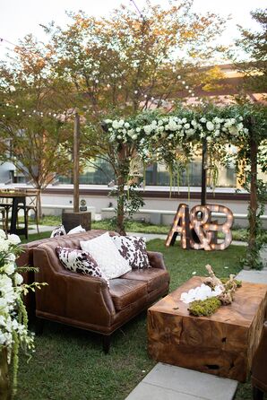 Rooftop Cocktail Hour in Nashville With Leather Couches, Hanging Flowers and Wood and Leather Details