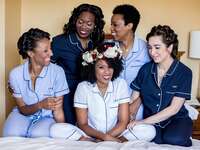 bride and bridesmaids posing in coordinating navy and light blue pajama sets
