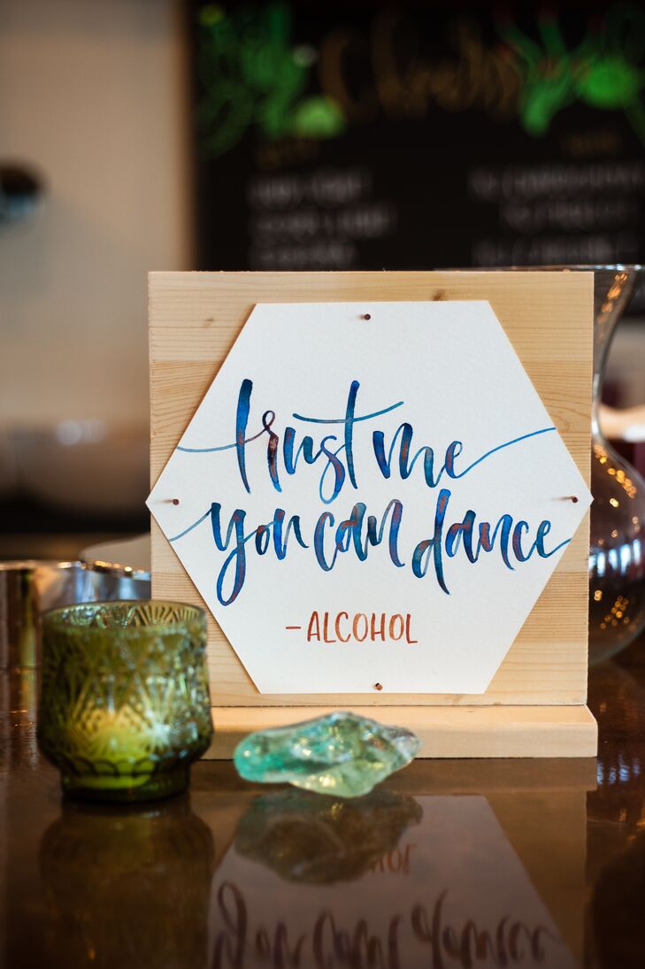 Calligrapher L Shannon Designs crafted all the signs for the event, including this playful piece (placed at the reception's bar).