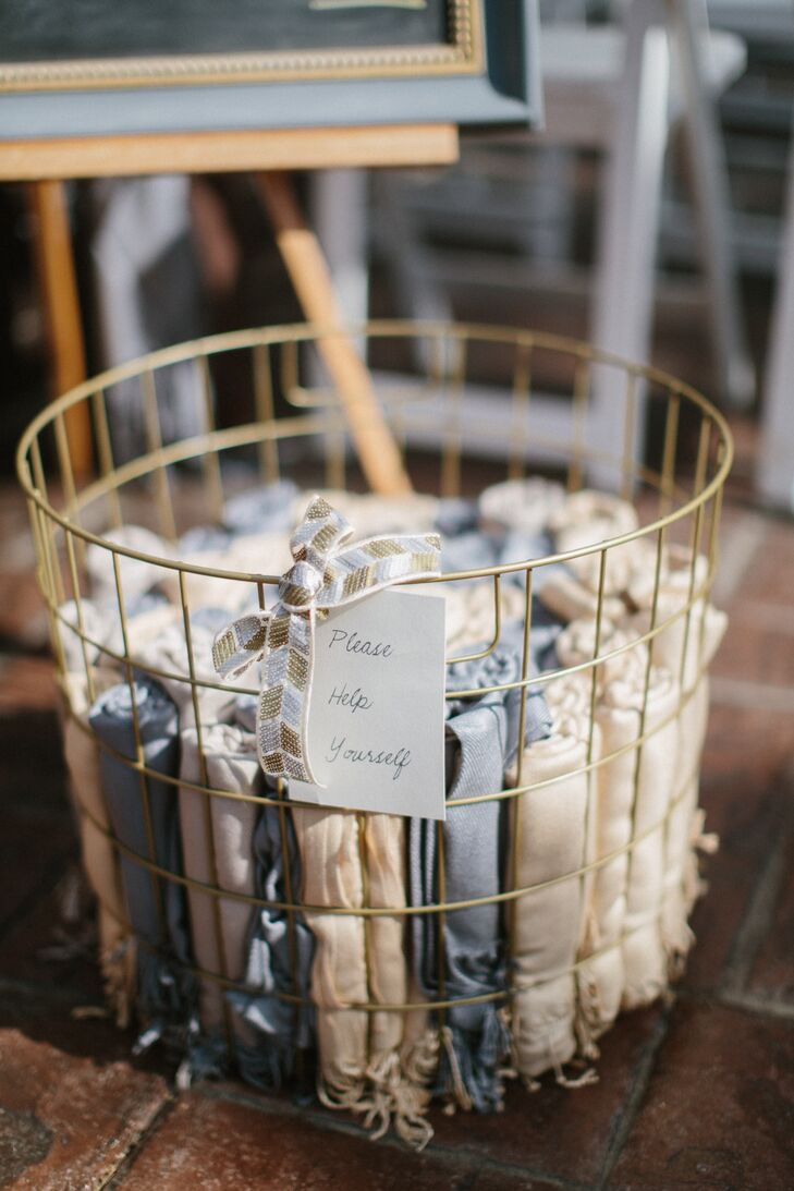 To ward off the chill air, vintage wire baskets full of ivory and light-blue shawls were placed at the front of the ceremony.