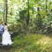 Newlyweds Kiss Amongst the Trees
