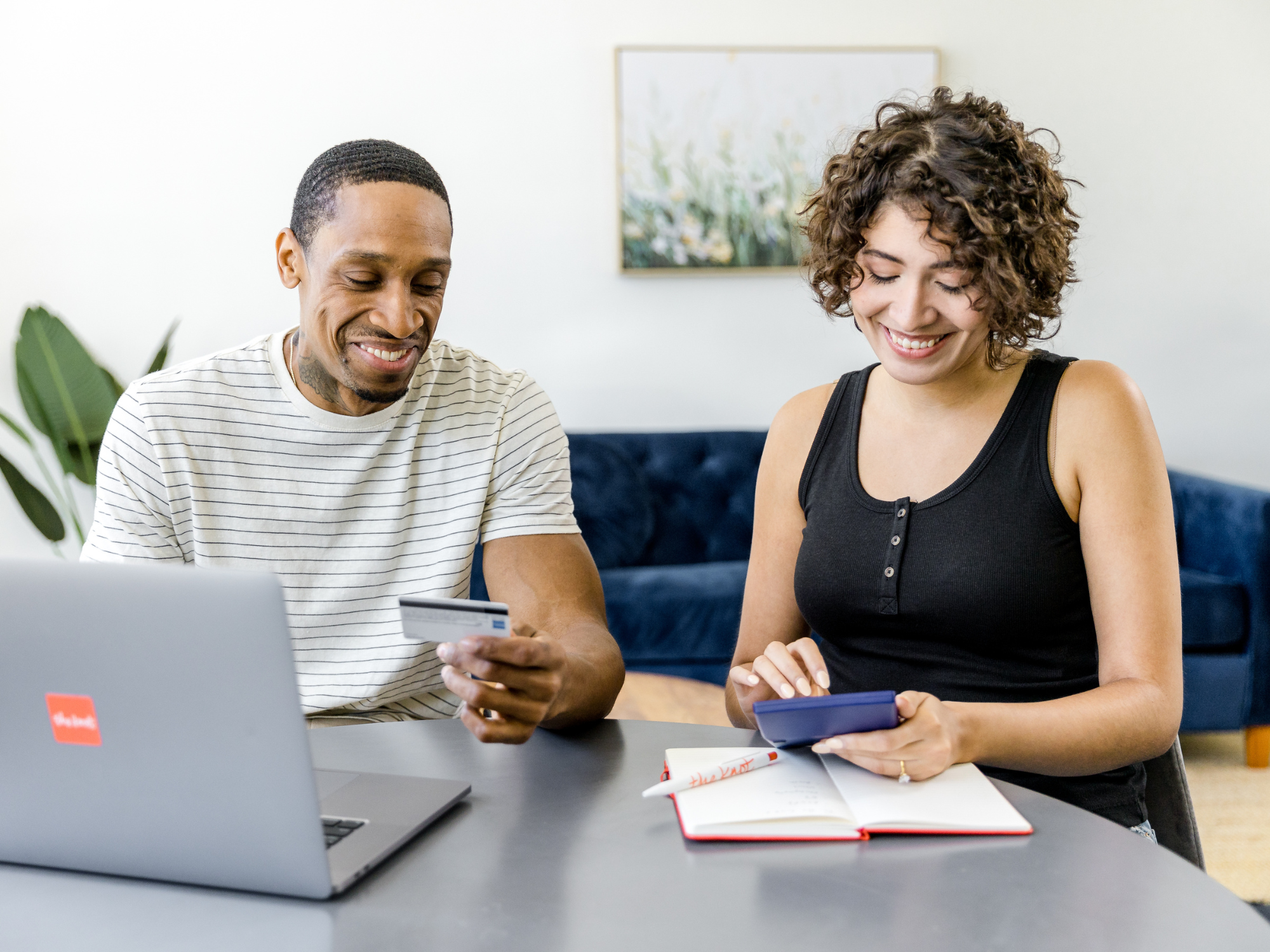 Couple looking at budget on computer