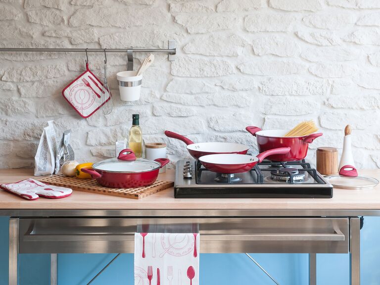 red pots and pans in kitchen on counter and stove