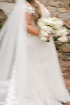 Action-Shot of Bride's Gown, Veil and White Bouquet Walking