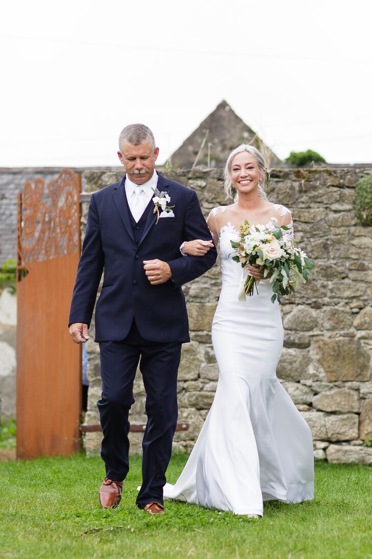 Since Elizabeth is a wedding dress designer, making her own gown was an obvious choice. “Upon our engagement, I was graduating, working as a designer’s assistant and finishing my senior collection, but this didn’t stop me from making my wedding dress,” Elizabeth says. The designer repurposed French Alencon lace from her mother’s wedding dress and tacked it to her gown. “I blended my modern taste with the location of the wedding, which resulted in a stark white, silk trumpet-style gown with illusion sleeves and a deep back. The hand-tacked lace softened the edginess for a dreamy, organic look.”