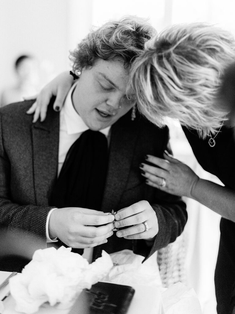 mother of the groom giving gift to groom at rehearsal dinner
