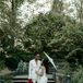 Bride With Parasol Posing With Bride in White Suit