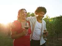 Couple in love walking through vineyard for winery proposal