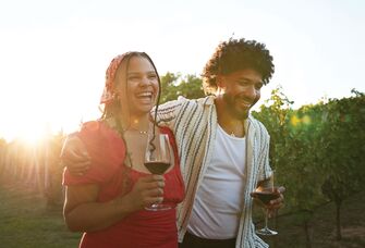 Couple in love walking through vineyard for winery proposal