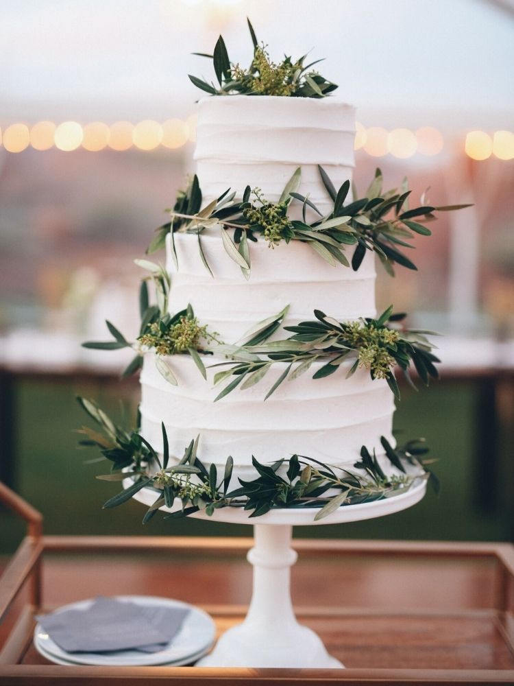 three-tier wedding cake decorated with olive branches 