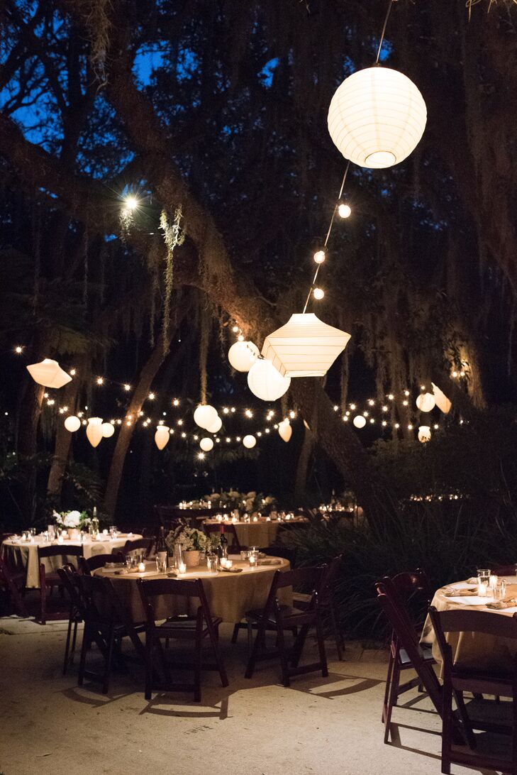 Strands of paper lanterns—left over from a previous wedding—floated above the tables.