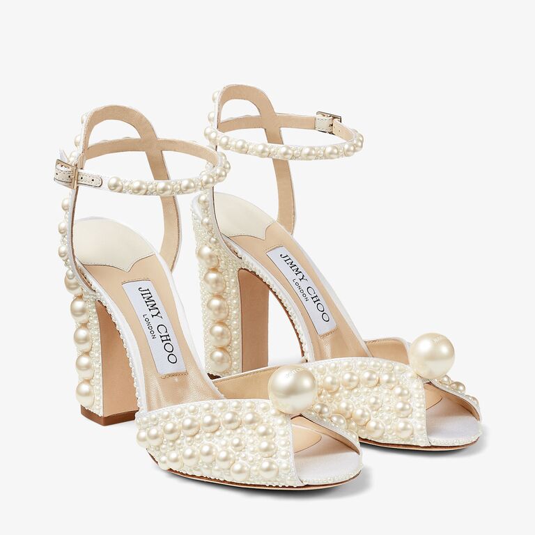 High white heels embellished with beautiful round pearls. 