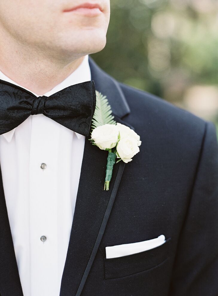 “Matt has great style and truly needed a little help from me with his look for the day,” Nina says. The groom stuck with a classic black tux paired with a black-on-black paisley bow tie. For a fun pop of hidden color, Matt gave his groomsmen bright, striped Happy Socks.