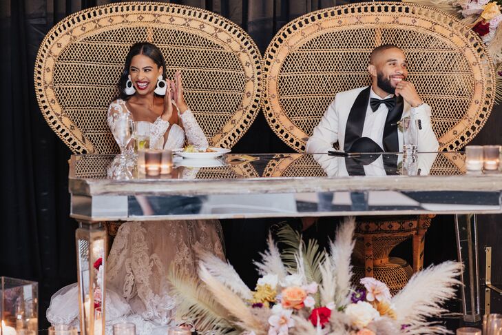 Bride and Groom in Woven Peacock Sweetheart Chairs