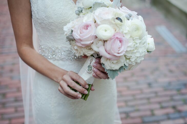 The bride carried a romantic bouquet filled with ivory ranunculus and hydrangea along with pink roses.