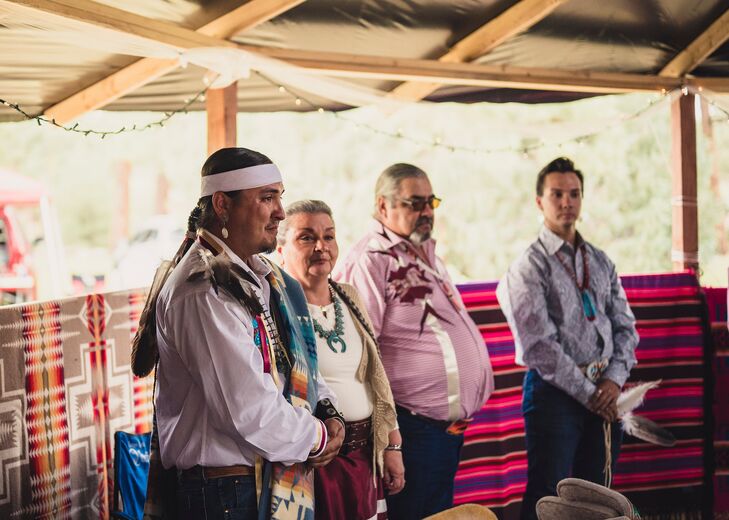 Groom and Family in Traditional Native American Attire During Ceremony