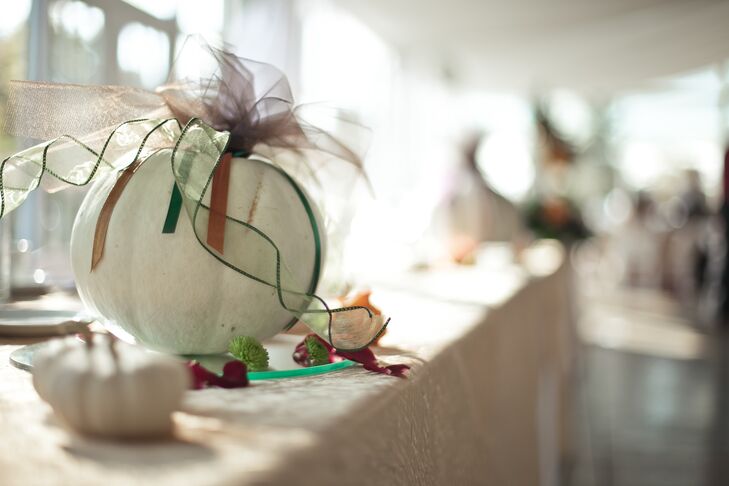 The bride and groom used white pumpkins instead of orange for the reception decor because it felt more appropriate for a wedding.