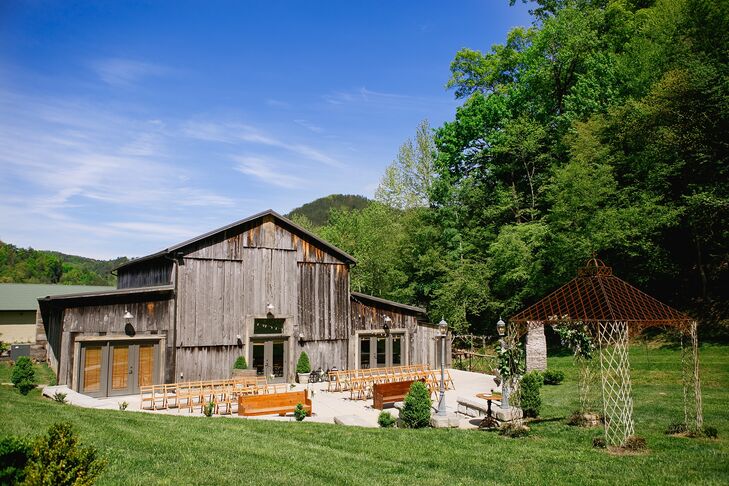 The intimate patio at the Barn at Chestnut Springs in Sevierville, Tennessee, doubled as a pretty ceremony space and a dance floor illuminated by bistro lights. Nearby on the lawn, guests played corn hole and gathered around the outdoor fireplace for a s'mores bar.