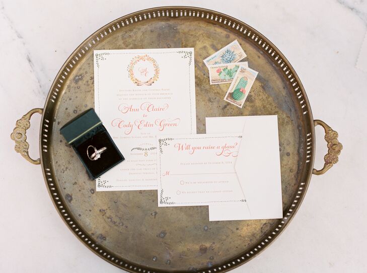 The white wedding invitations had elegant floral designs accenting its pages—from the wreath wrapped around Ann and Cody's initials at the top to the corners accented with leafy greens.