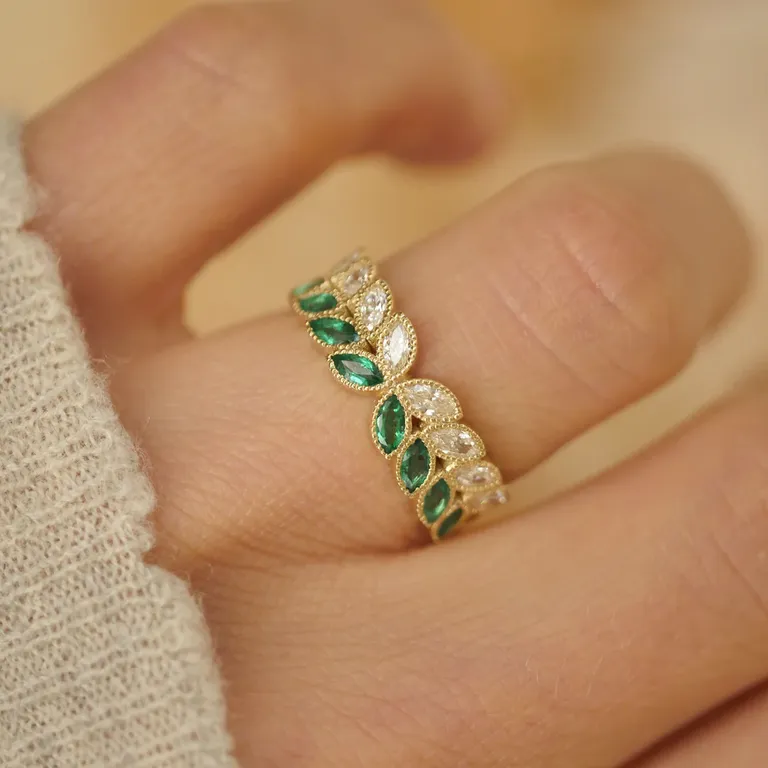yellow gold band with two-tone ring with octets of natural marquise-cut diamonds and emeralds in floral pattern