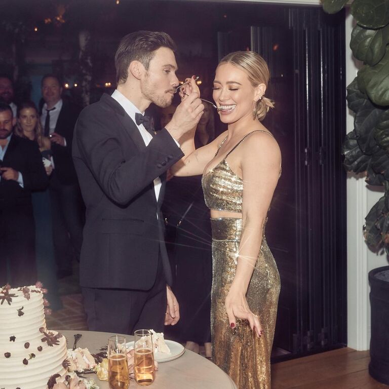 Hilary Duff and Matthew Koma tasting their wedding cake