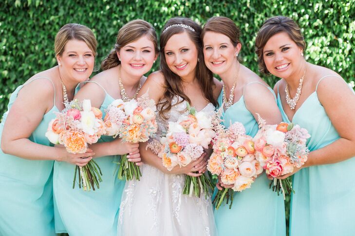 While she didn’t have a specific flower preference, Stephanie knew she wanted citrus-inspired colors for the bridesmaid bouquets. Each arrangement was a smaller version of Stephanie's, with a mix of orange ranunculus, peach peonies, pink astilbes, succulents, dusty miller, white peonies and pink astilbes. The cute combination had a soft nod to their theme while still maintaining a chic palette.