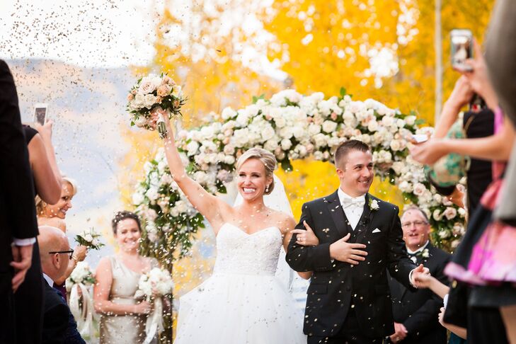 Although Chris is Catholic, it was important for Emily to have a somewhat traditional Jewish ceremony, including being married by a rabbi under a huppah (symbolized by the floral arch).