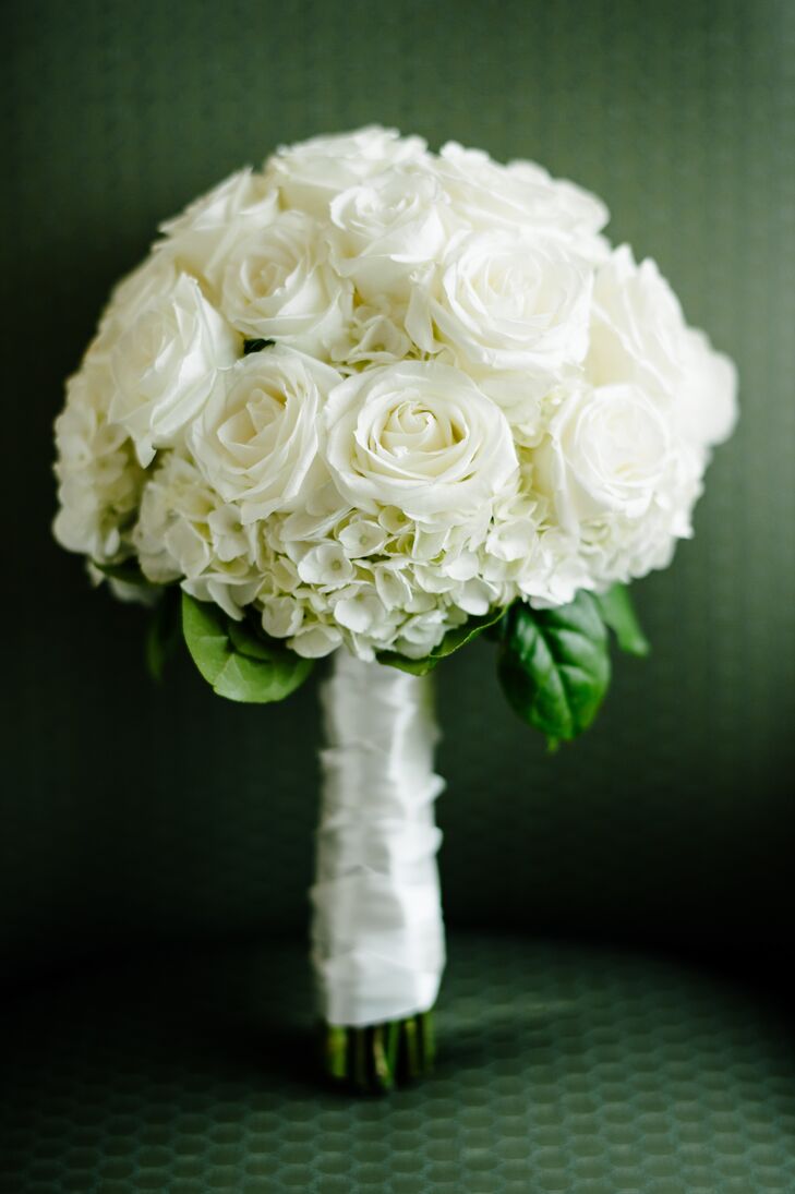 Meredith's bouquet had a classic, elegant feel. The bouquet was filled with ivory roses and hydrangeas and was wrapped with a length of white ribbon.