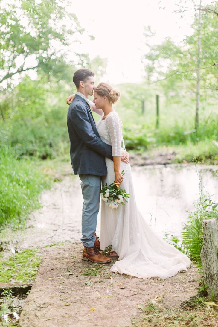 The bottom of Megan's ivory wedding dress train bundled behind her as she faced Carson. She wore a classic gown that blended in with the environment's natural colors.