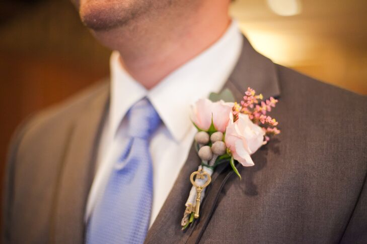 A small, antique key was tied to the groom's pink rose boutonniere.