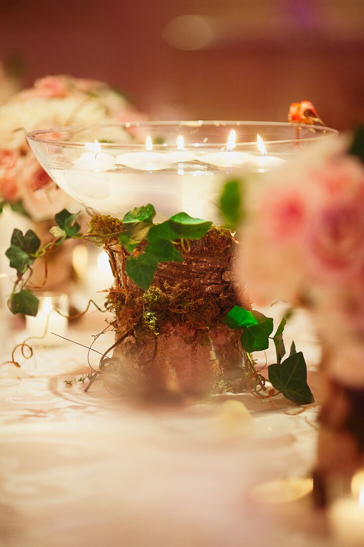 For the family-style tables the centerpieces were birch tree trunks covered in moss and ivy with glass bowls of floating candles.
